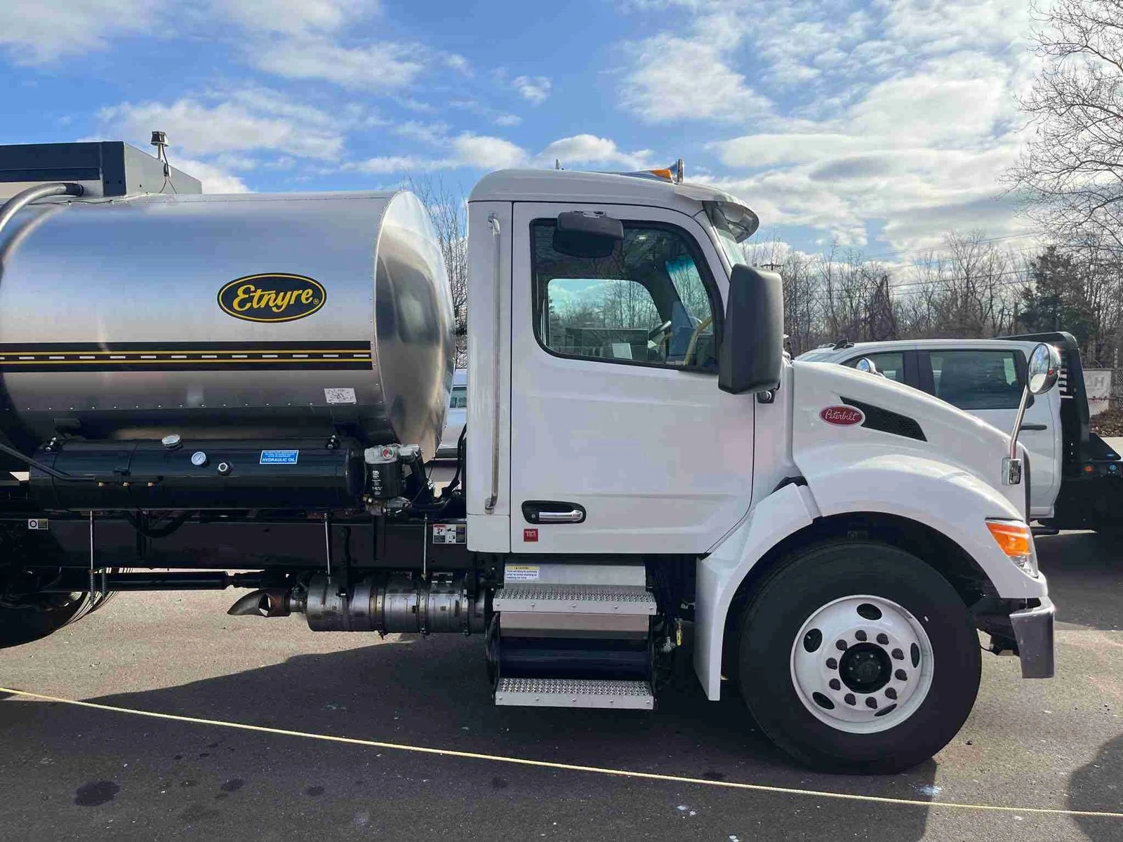 Commercial tanker before refinishing, with a white cab