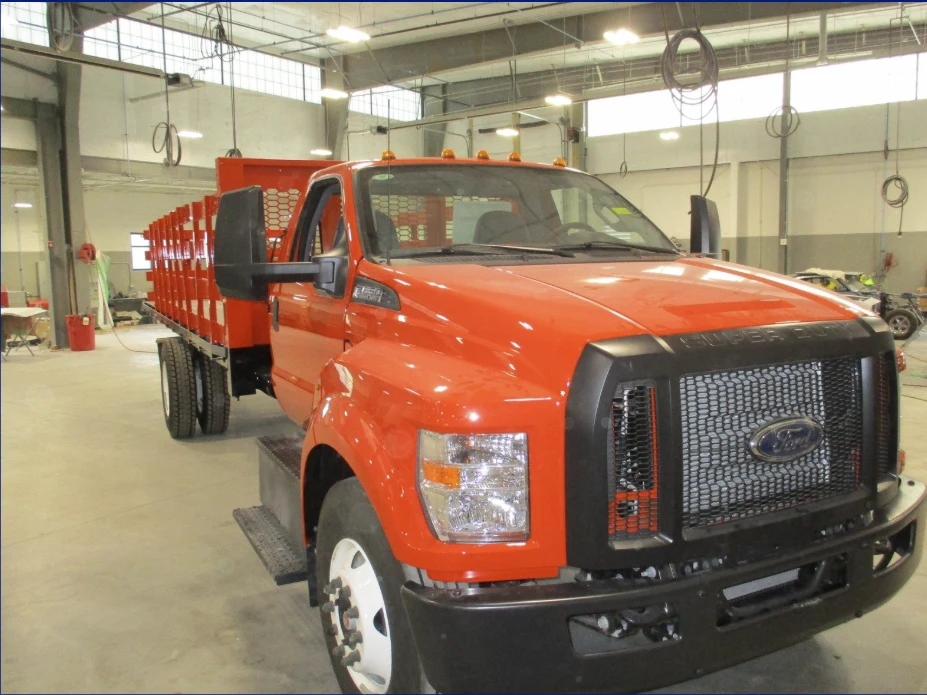 Orange commercial truck in Heritage’s workshop