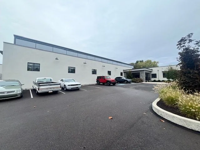 Exterior view of the main building with parked cars